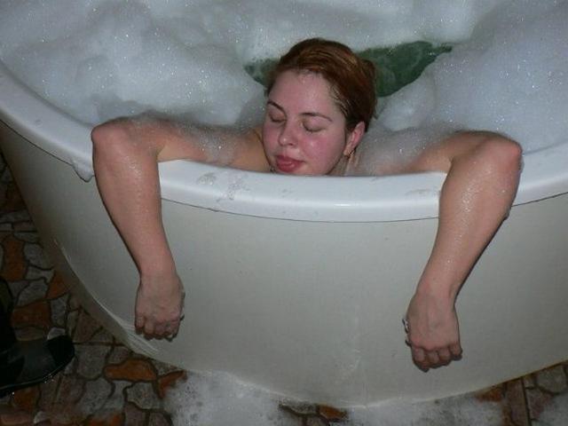 Red-haired beauty posing in the bath 7 photo