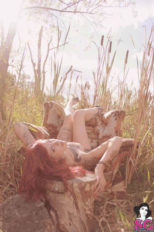 Redhead lusty babe in a tattoo posing on country meadow 11 photo