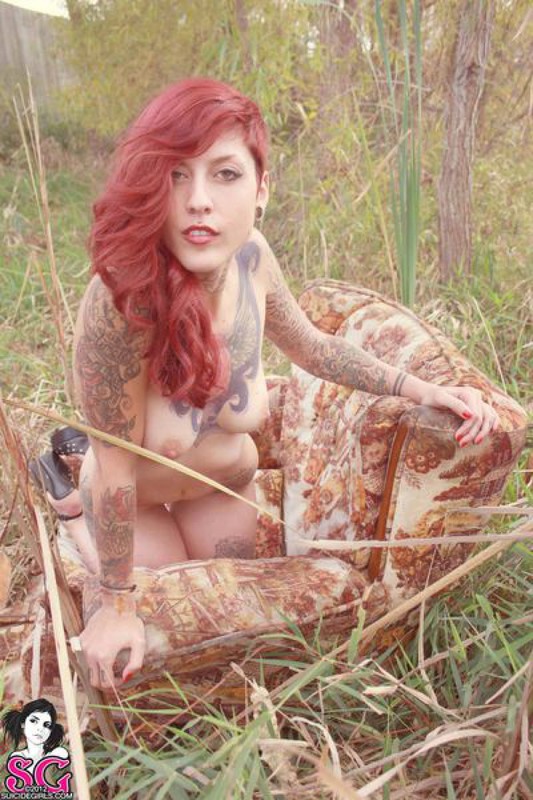 Redhead lusty babe in a tattoo posing on country meadow 25 photo