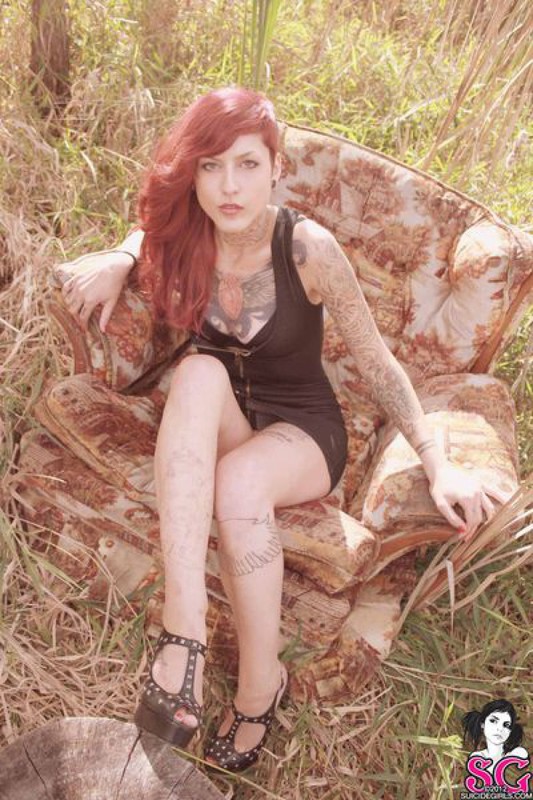 Redhead lusty babe in a tattoo posing on country meadow 33 photo